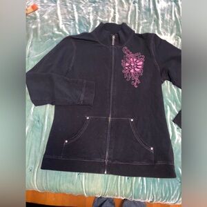 Super cute black + pink zip up sweater. Design on front. Worn once or twice